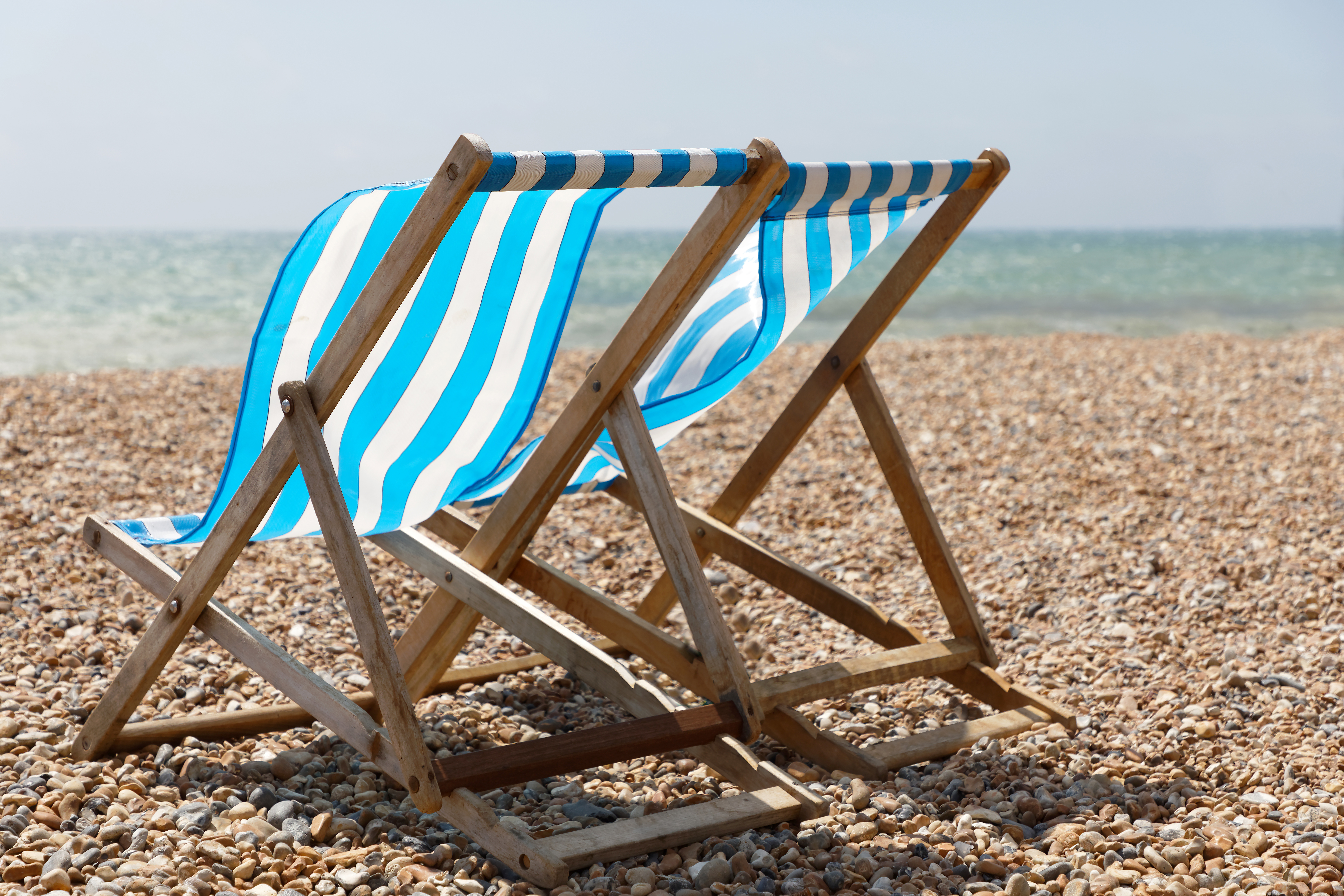 Deck chairs on a breezy Brighton beach