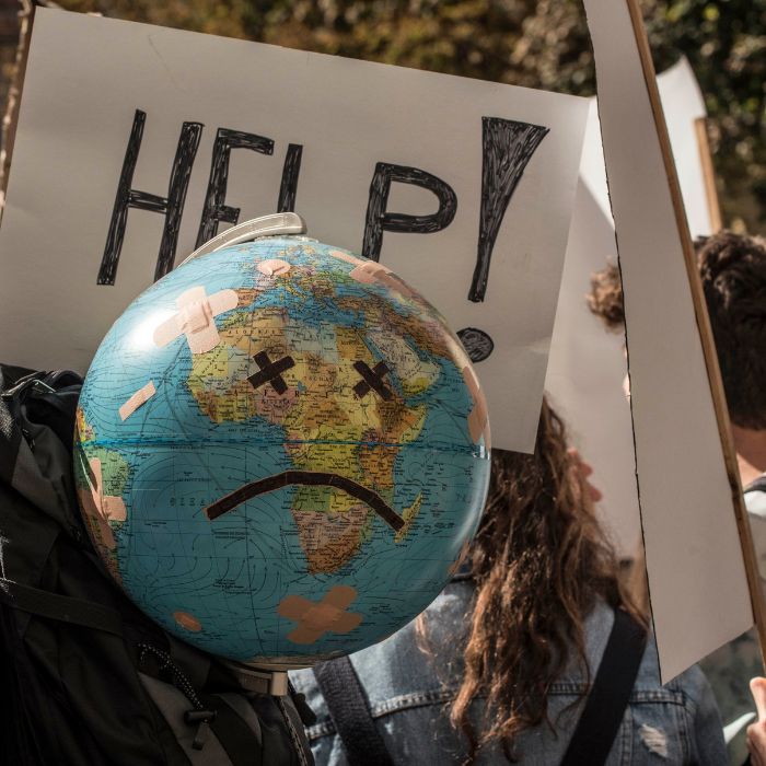 A protester carries a replica of an Earth