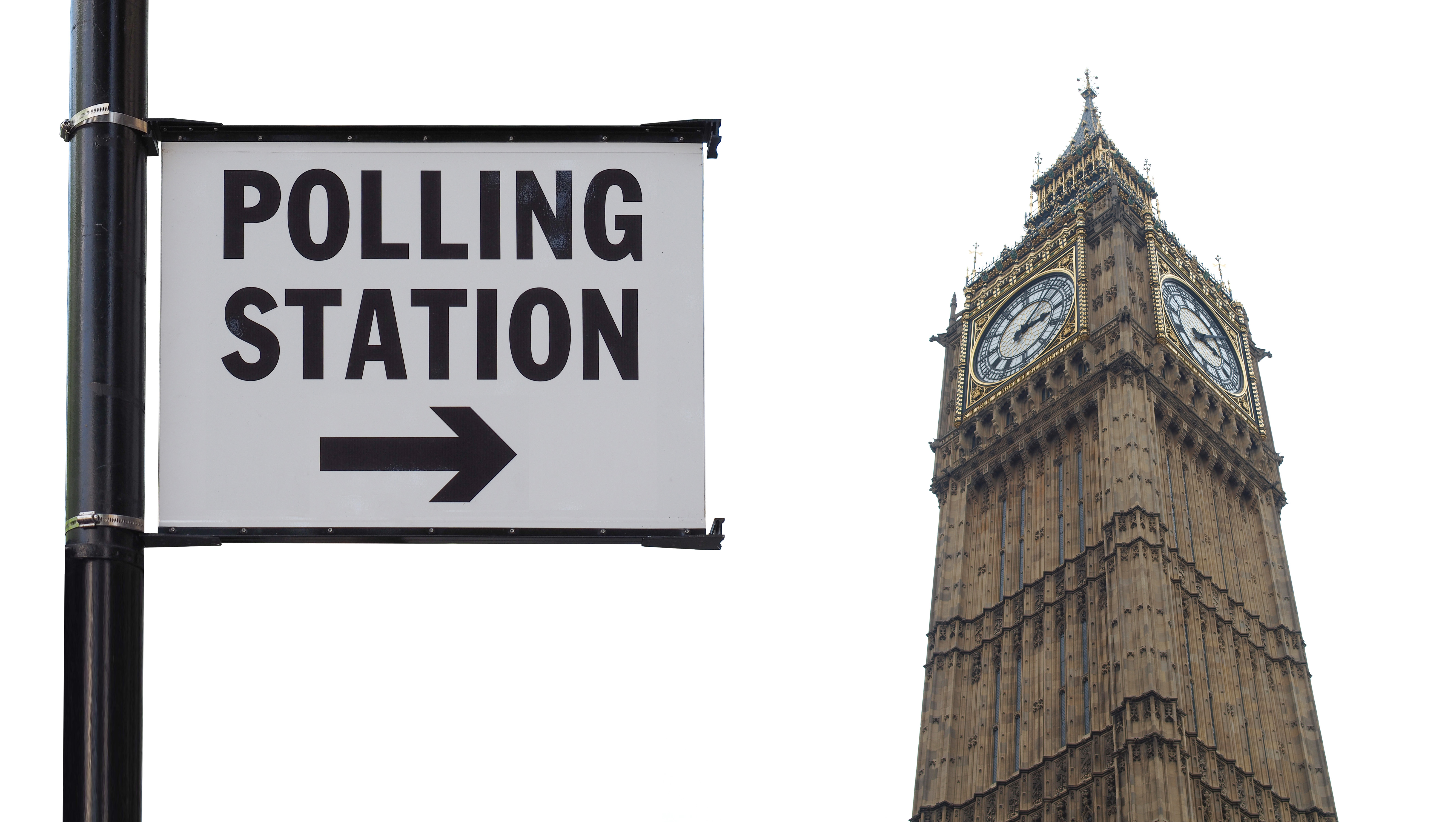 Polling station sign against the Elizabeth Tower and a cloudy sky