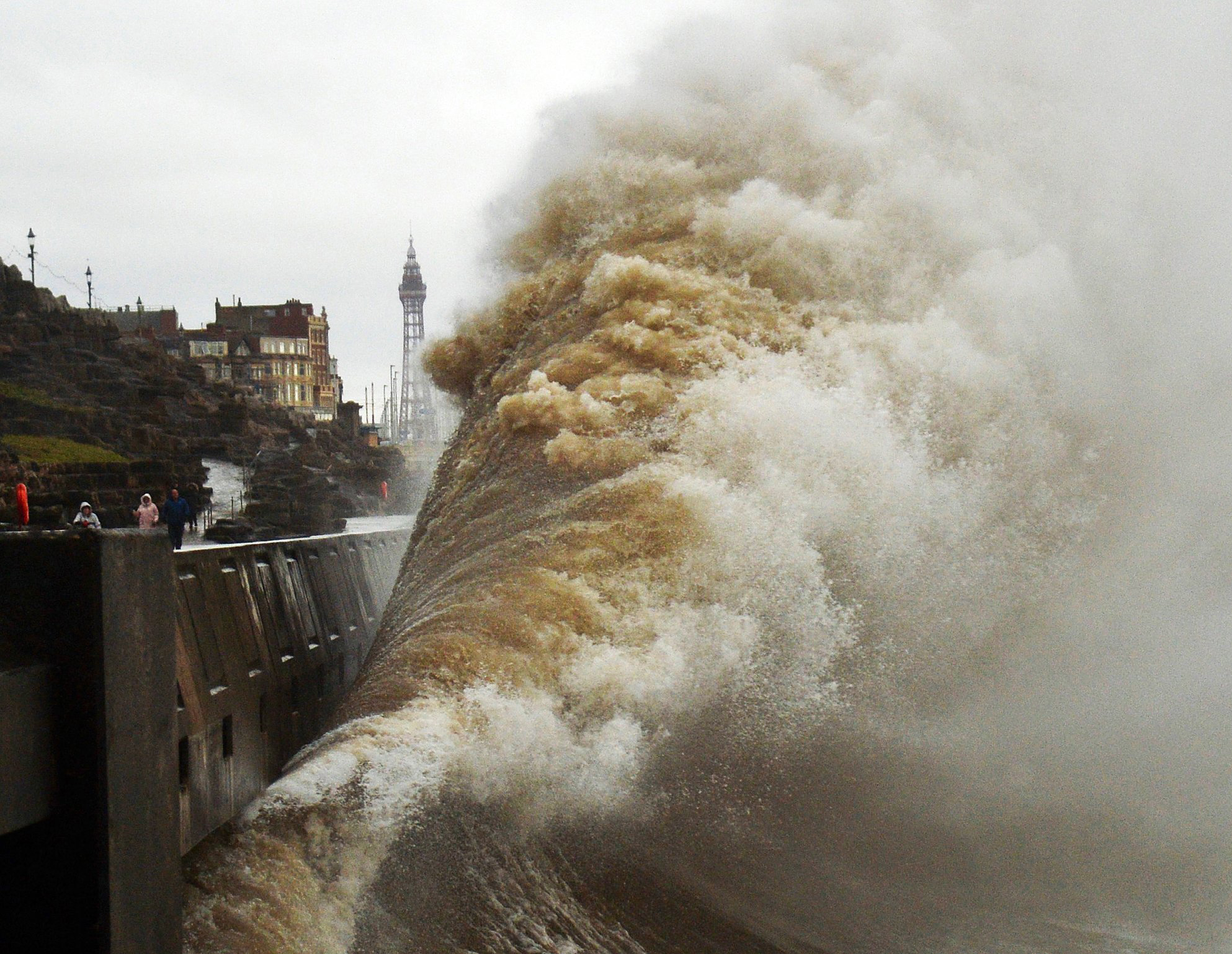 A wave created by Storm Dennis crashes into a tidal barrier in Blackpool