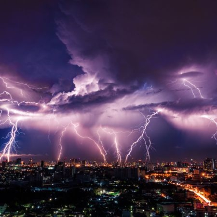 Lightning flashes in a deep purple sky